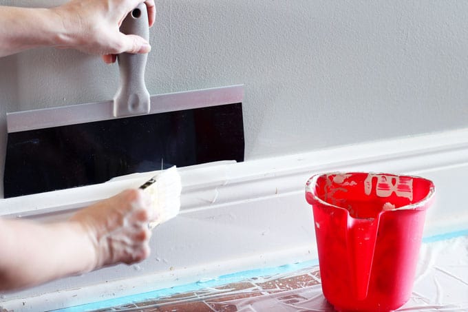 Painting baseboards with painters sheild